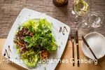 Fresh green salad on a plate in a restaurant.