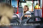 A woman is sitting on the bus.